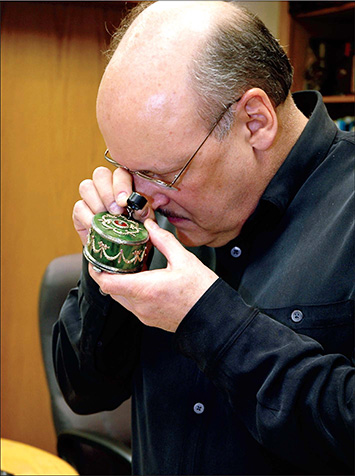 Joe Murawski inspecting jewelry with a gemologist's loope