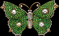 Yellow gold butterfly brooch with 4 pear shaped natural colored diamonds with 2 emerald cut diamonds with emeralds and 4 pearls